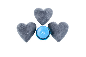 Blue candle with heart rocks