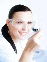 Closeup of a female researcher holding up a test tube