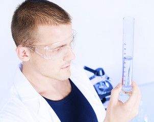 Closeup of a researcher man holding up a test tube