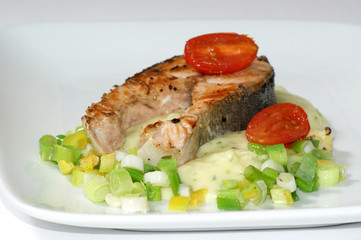 grilled salmon fillet on mashed potato and spring onion