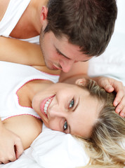 Obraz na płótnie Canvas Man kissing his grilfriend in bed
