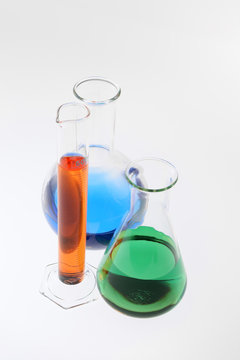 Assorted laboratory glassware with multicolored liquid