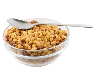 Glass bowl of cold cereal flakes . Isolated