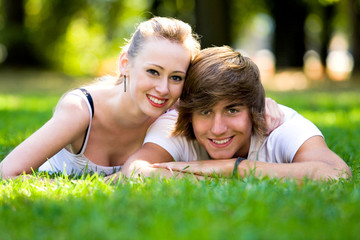 Young couple lying down and smiling