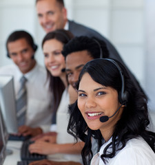 Portrait of a businesswoman in a call center with her team