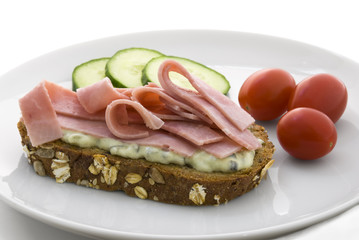 Traditional swedish bread slice with cucumber salad and ham