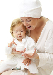 picture of happy mother with baby holding cosmetic cream