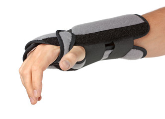 Human hand with a wrist brace, orthopeadic equipment