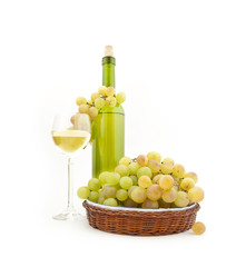 Obraz na płótnie Canvas Bottle of white wine and white grapes on a dish