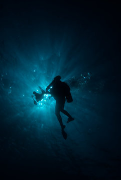 Silhouette of a diver with sunburst