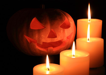 Jack O' Lantern surrounded by candles