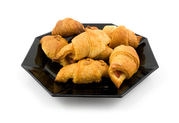 Plate with home made croissants over white background