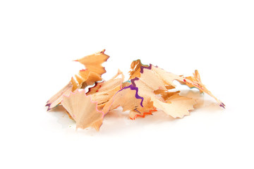 colorful pencil shavings over white background