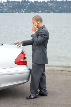 Ethnic Business Man Making a Sale on Cell Phone