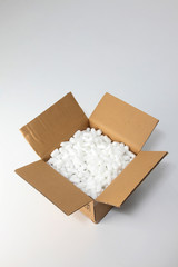 open box with packing 'peanuts' inside on the plain background