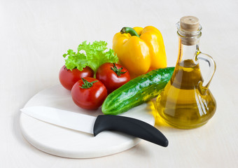 Healthy food still life with white ceramic knife