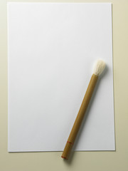 brush and  paper . Traditional calligraphy set on a bamboo mat
