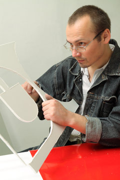 Adult male works in an advertising studio
