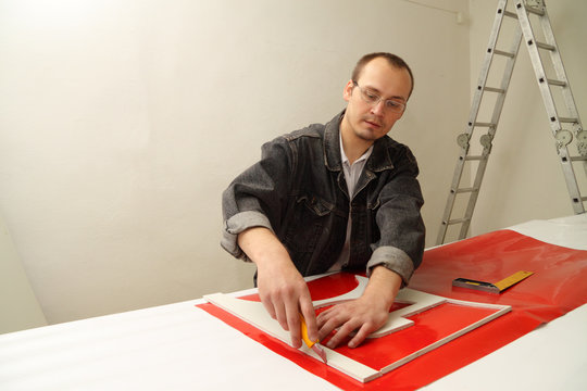 Adult male works in an advertising studio