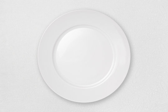 Empty Plate on a White Tablecloth