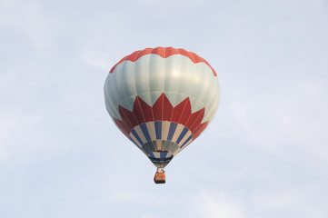 Colorful air balloon flies high in the sky