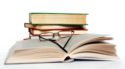Books and glasses on white. Contains clipping path.