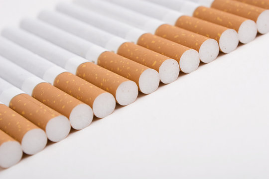 A line of cigarettes on the white