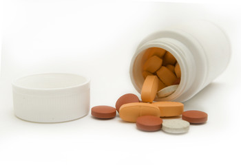 White bottles and pills macro, isolated