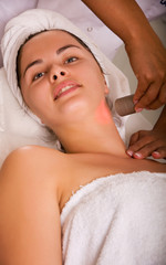 Young woman getting skin cleaning at beauty salon (shallow dof)