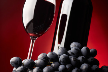 Glass and bottle of red wine.