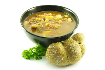 Vegetable Soup in a Black Bowl with Bread Bun