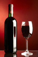 Glass and bottle of red wine.
