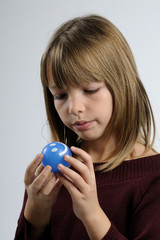 girl admiring blue ball
