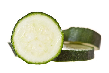 Sliced baby marrow on a white backround