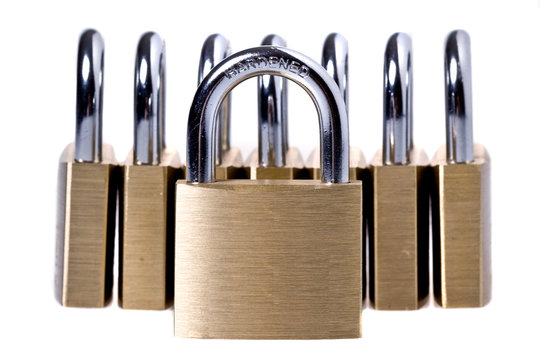 Brass padlockes on a white background