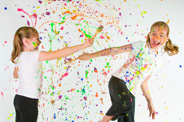 Two kids playing with paint