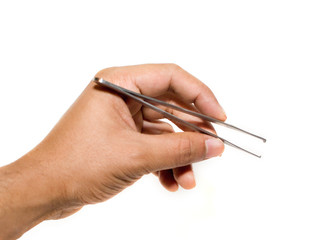 Forceps being held by a hand isolated on a white background