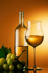 bicchiere di vino bianco con bottiglia