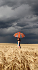 Girl with umbrella at field
