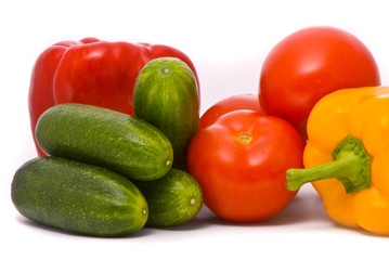 Fresh tomatoes, cucumbers and pepper on a studio white backgroun