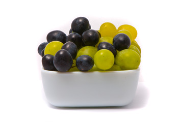 Green and blue grapes on a studio white background