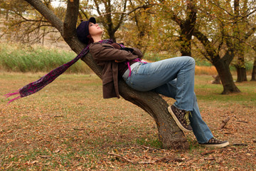 Girl lying at tree