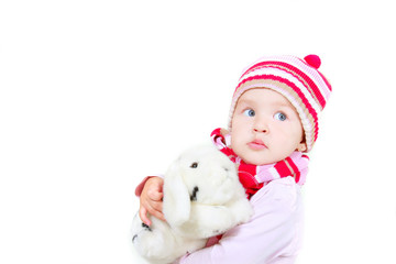 toddler girl with toy rabbit over white