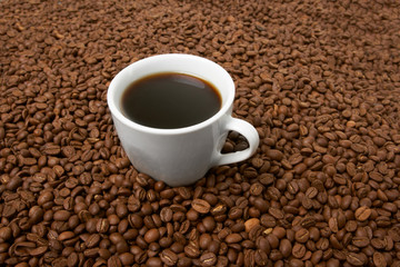 Cup with coffee, costing on coffee grain
