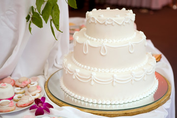 Three tiered wedding cake with white icing