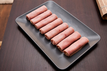 stuffed hams roll on the gray plate