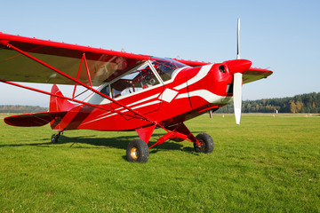 Small airplane on airfield grass