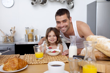 Obraz na płótnie Canvas Daughter having breakfast with her father