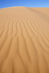 desert sand dune with blue sky