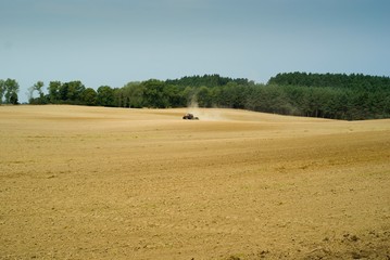 Obraz premium field with tractor at work